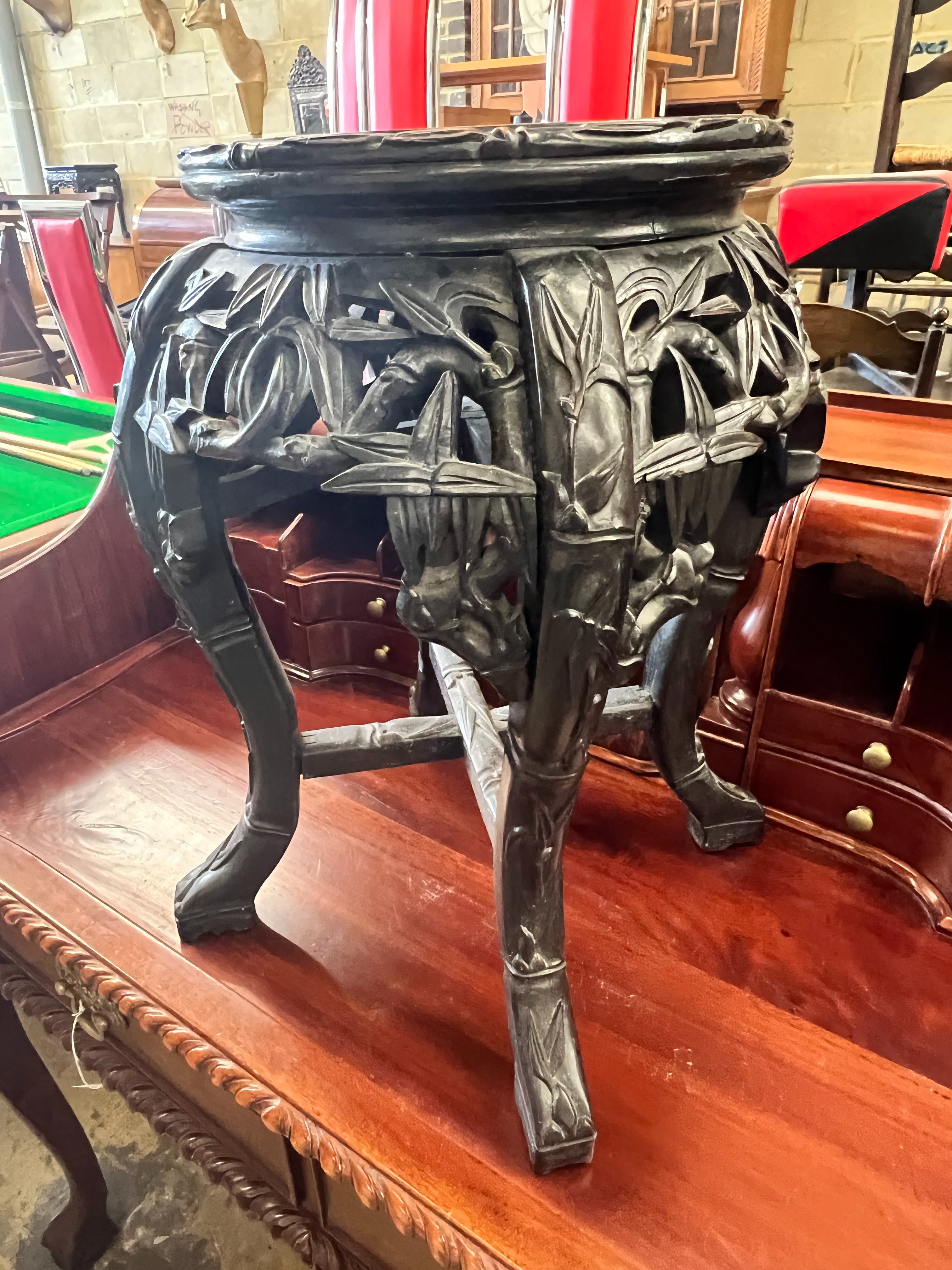 A Chinese carved hardwood circular marble topped vase stand, width 32cm height 47cm